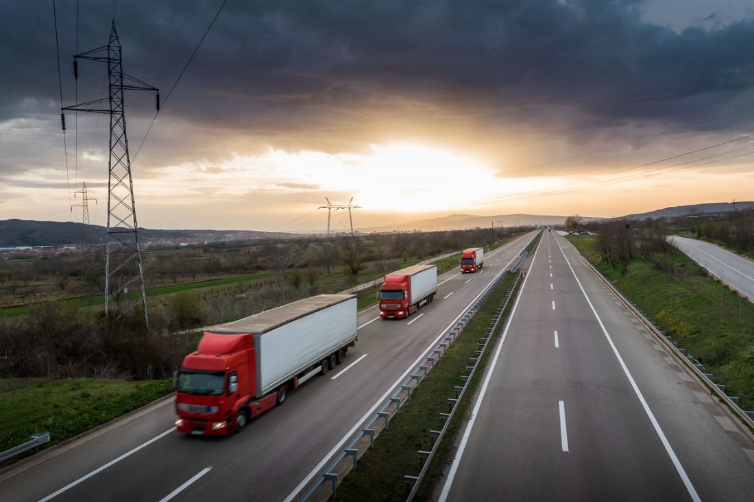 caravan or convoy of red trucks on highway picture id992850928